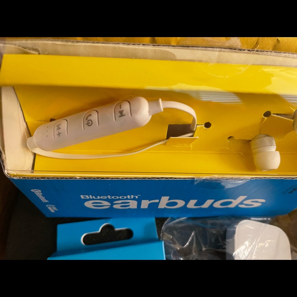 Bluetooth earbuds plus charging cable.